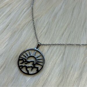 Sun mountain open work silvertone necklace